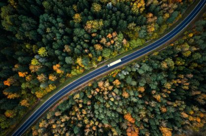 Arial view of a truck driving through a forest