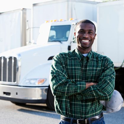 Man posing in front of a truck