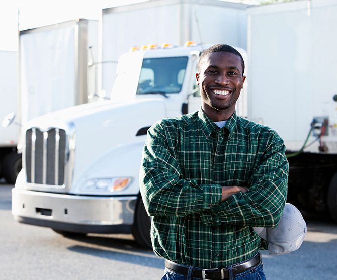 Man posing in front of a truck