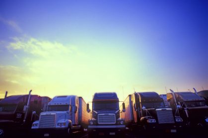 lineup of trucks at sunset